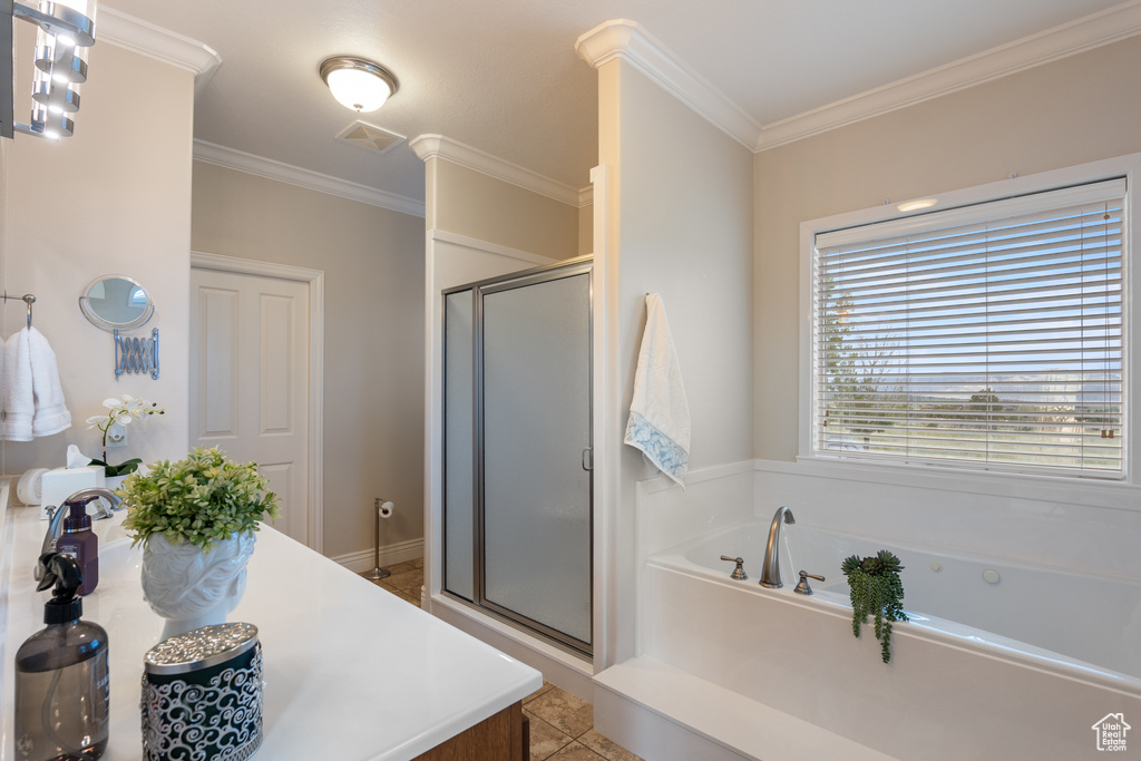 Full bathroom with a shower stall, ornamental molding, a garden tub, and tile patterned floors