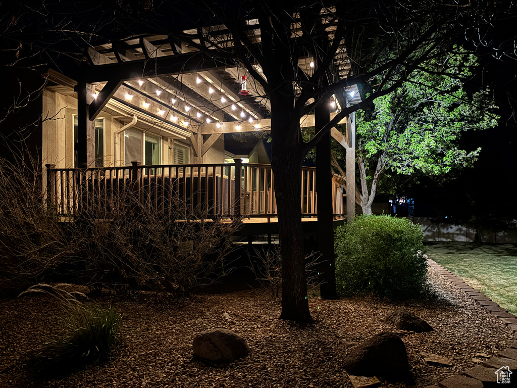 View of side of home with a deck and a pergola