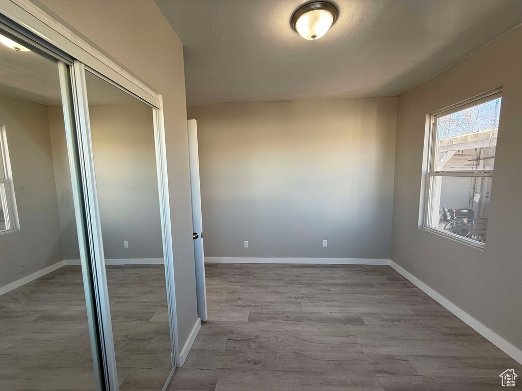 Unfurnished bedroom featuring light hardwood / wood-style flooring and a closet