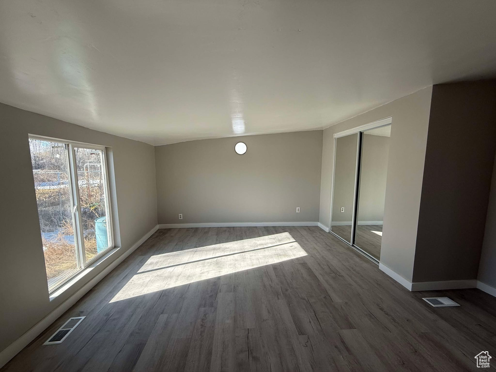 Spare room with dark wood-type flooring