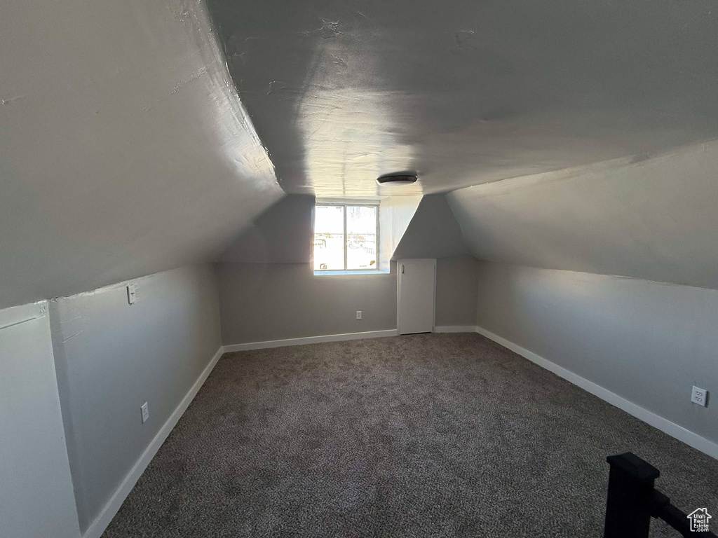 Bonus room featuring carpet and vaulted ceiling