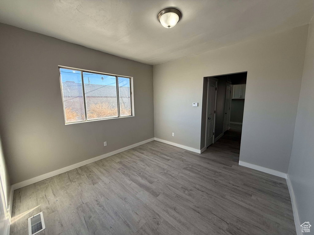 Unfurnished room featuring hardwood / wood-style floors