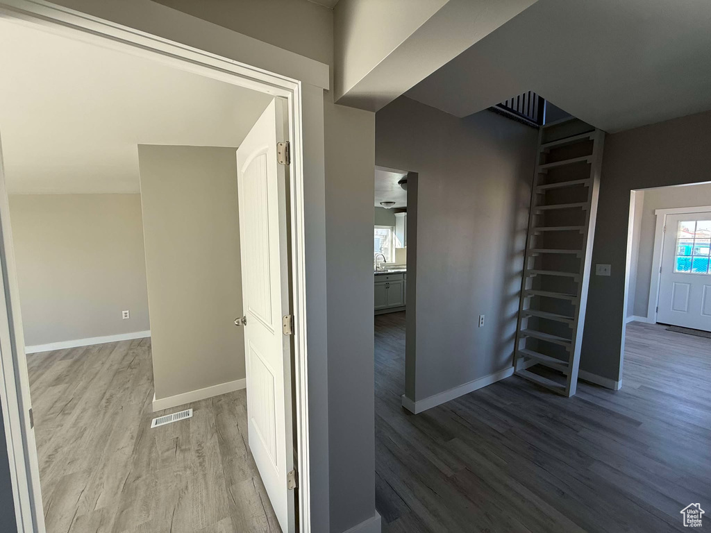 Hall with sink and hardwood / wood-style floors