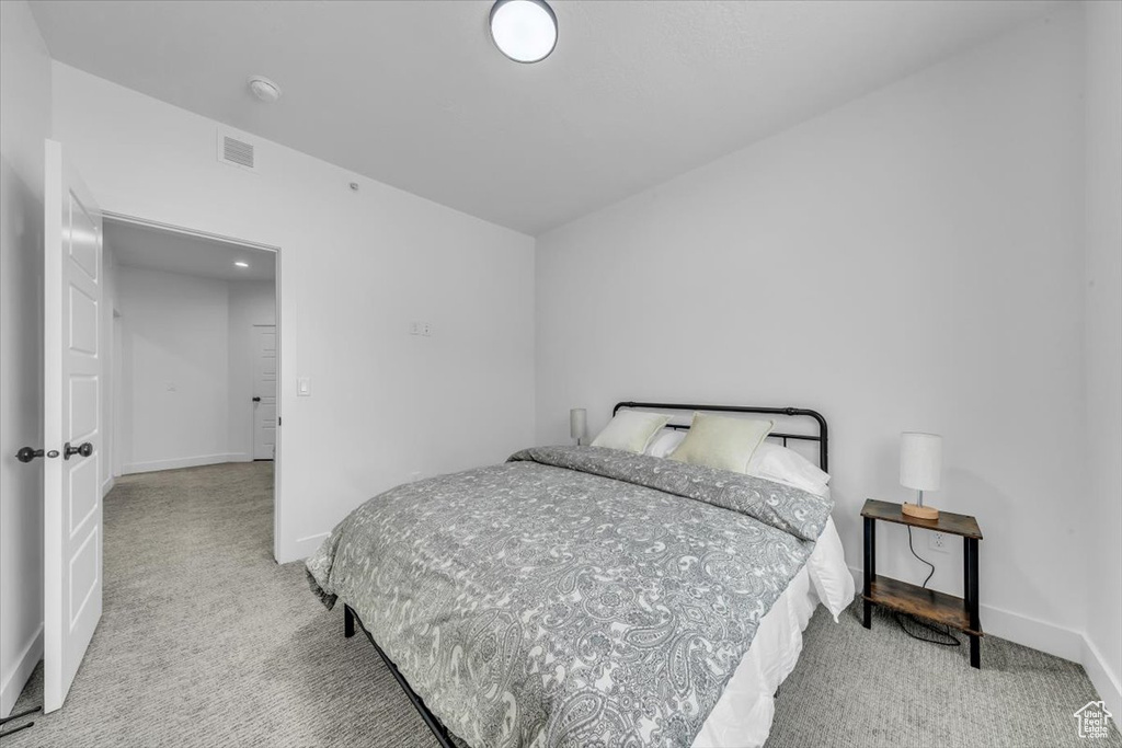 Bedroom with visible vents, baseboards, and carpet