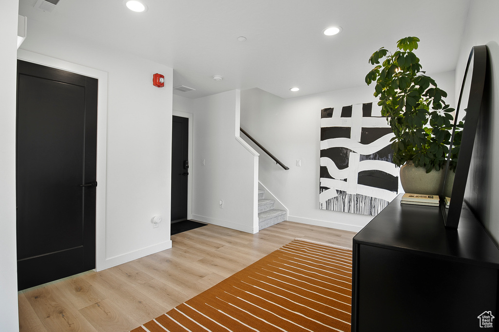 Foyer entrance with hardwood / wood-style floors