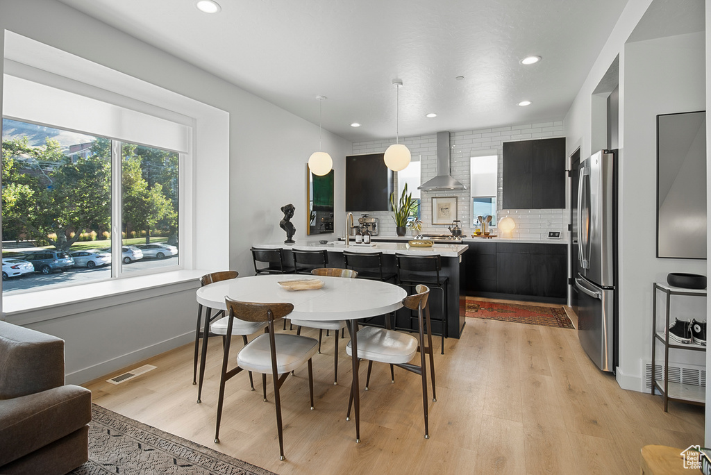 Dining room with light hardwood / wood-style floors