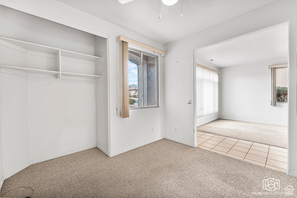 Unfurnished bedroom with carpet floors, a closet, and ceiling fan