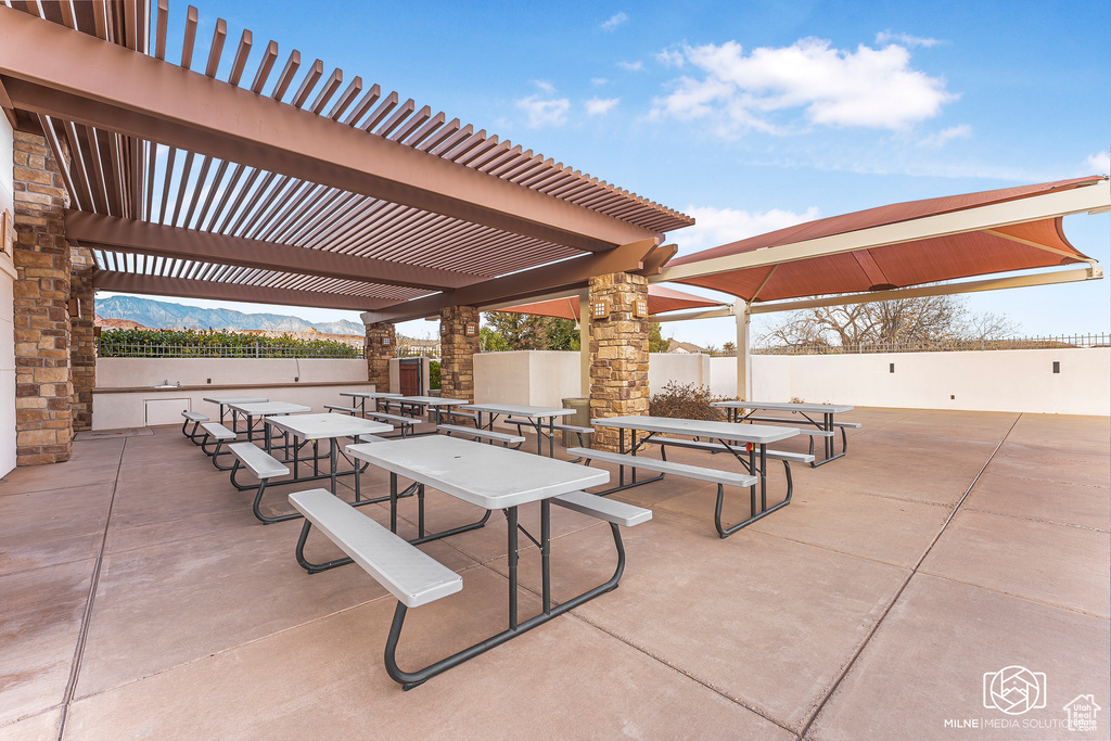 View of patio / terrace featuring a pergola and a mountain view