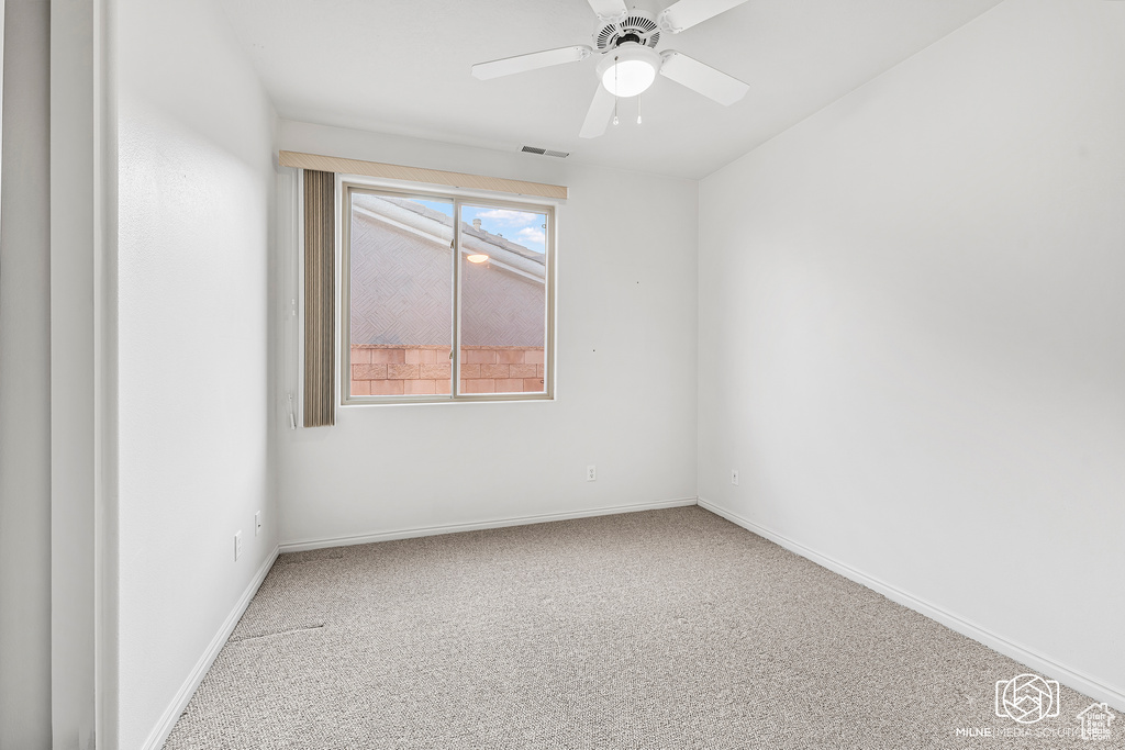 Unfurnished room with ceiling fan and carpet floors