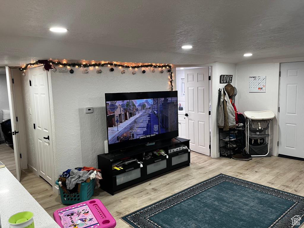 Living room with hardwood / wood-style floors and a textured ceiling