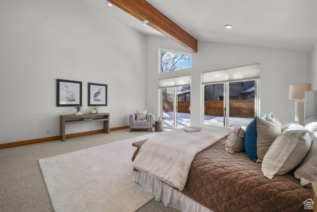 Bedroom with vaulted ceiling with beams, carpet floors, and access to outside