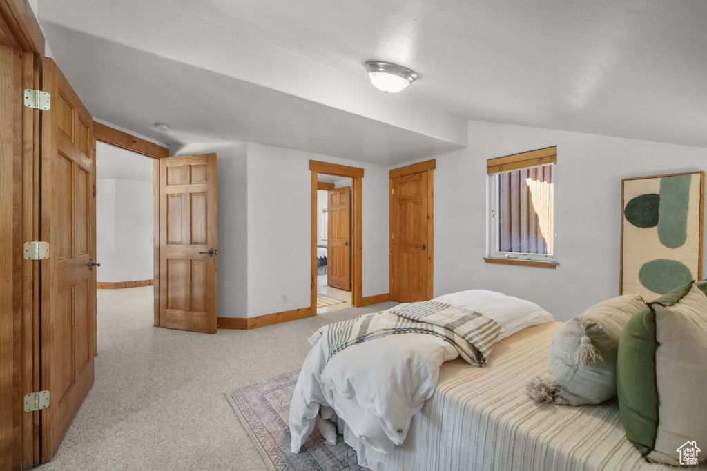 Bedroom with lofted ceiling and ensuite bath