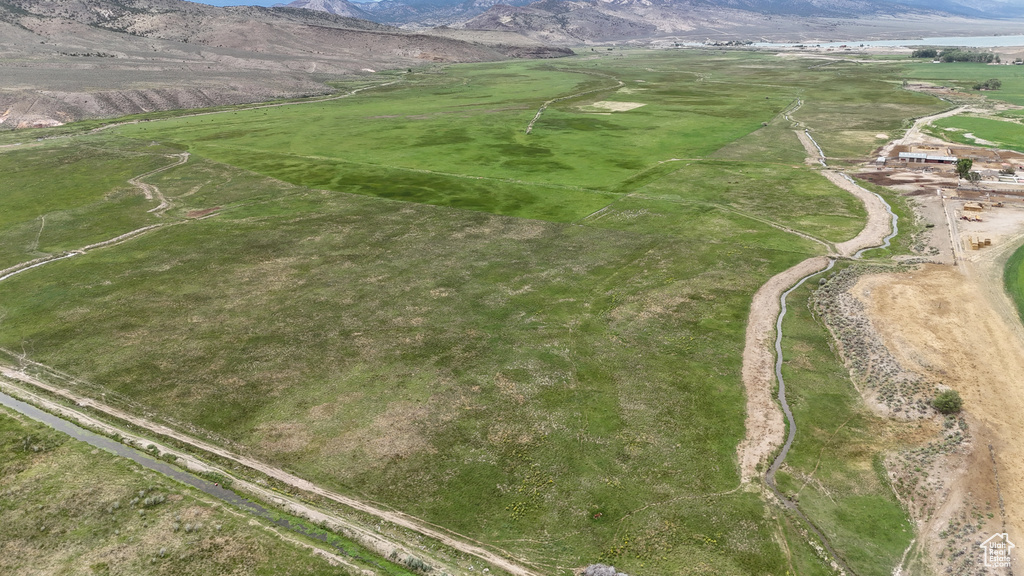 Aerial view of property and surrounding area featuring mountains and rural landscape