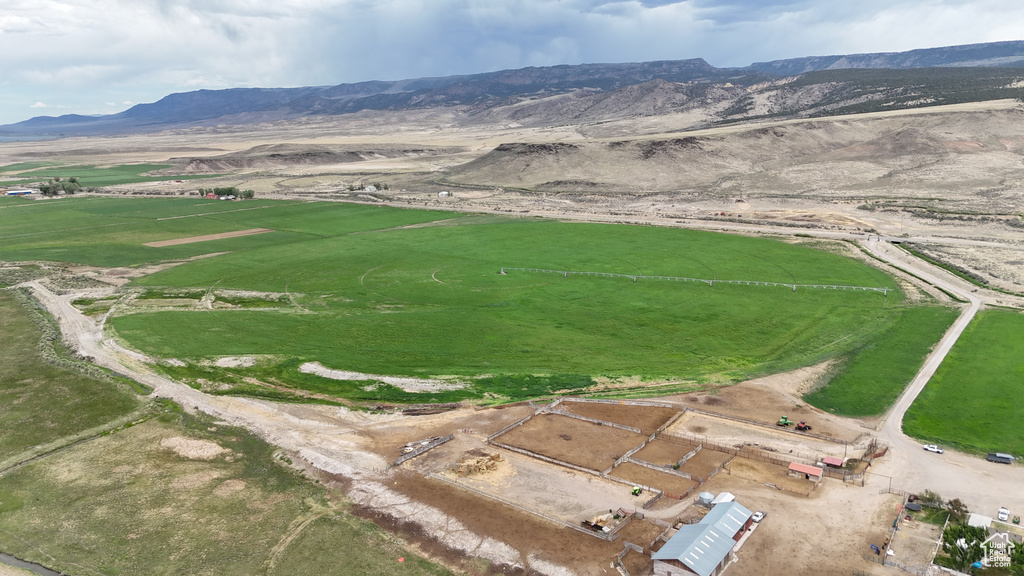 Aerial overview of property's location with a mountain backdrop and rural landscape