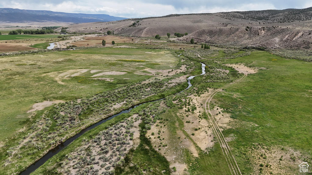 Aerial view of property's location with a mountain backdrop