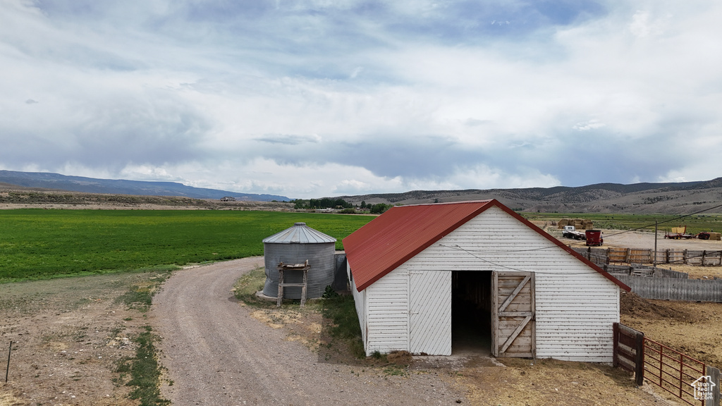 View of barn featuring a view of rural / pastoral area and a mountain view
