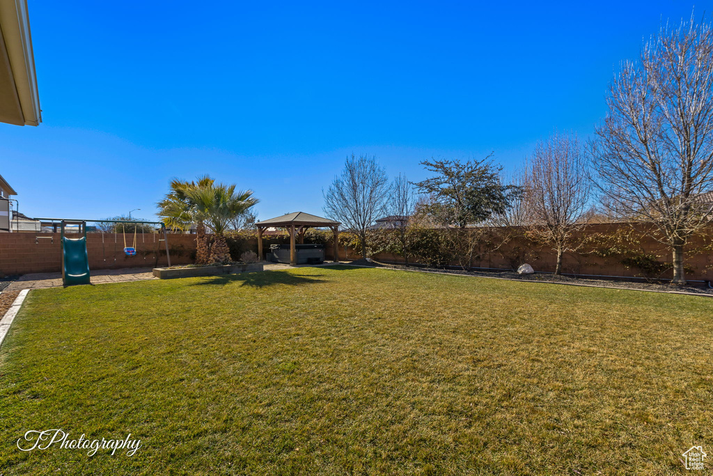 View of yard featuring a gazebo and a playground