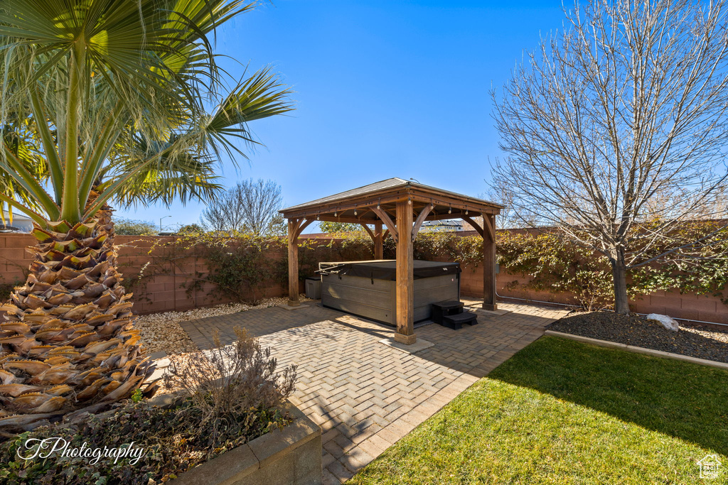 View of patio with a hot tub