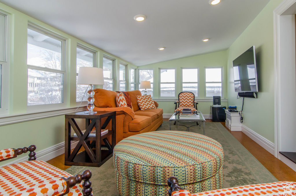 Sunroom featuring lofted ceiling