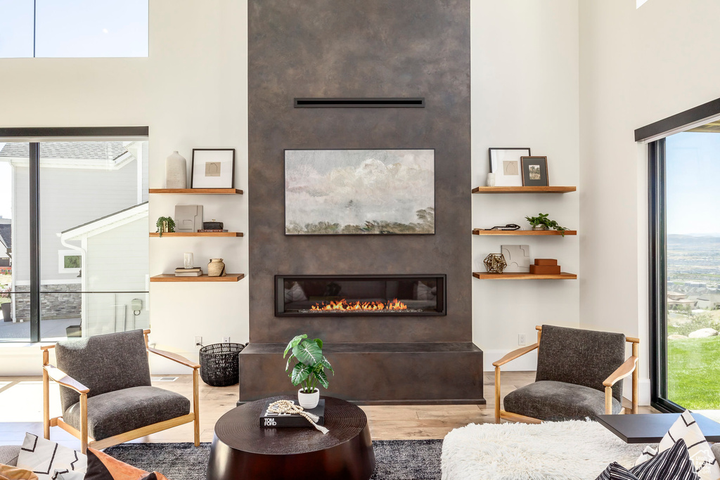 Living room featuring a large fireplace and hardwood / wood-style flooring