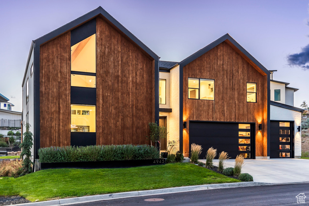 Contemporary home with a lawn and a garage