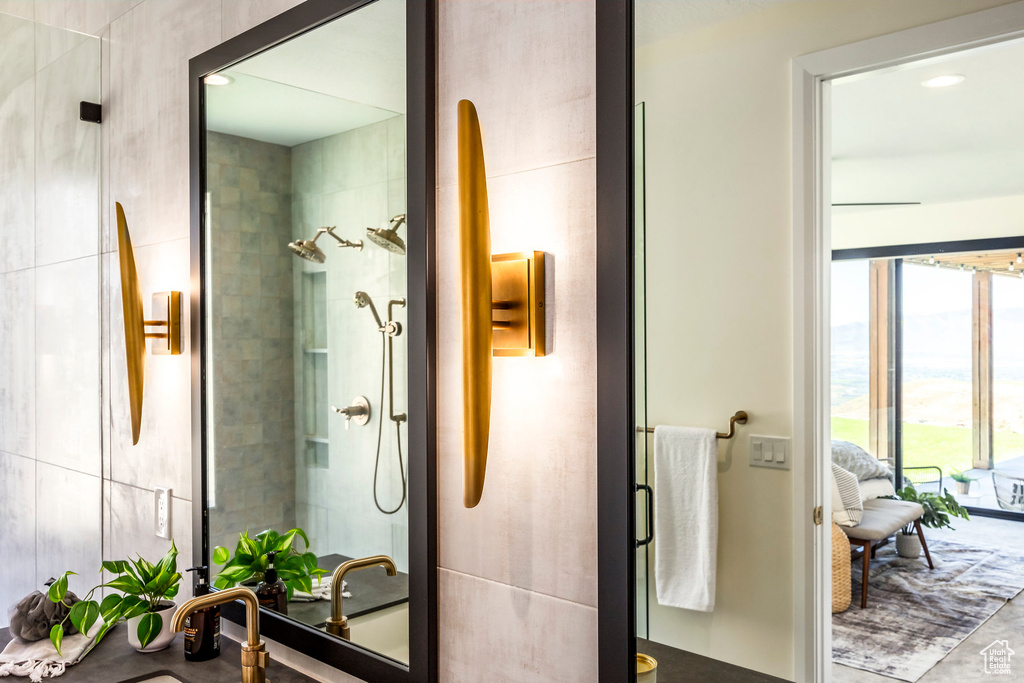 Bathroom featuring sink and tiled shower