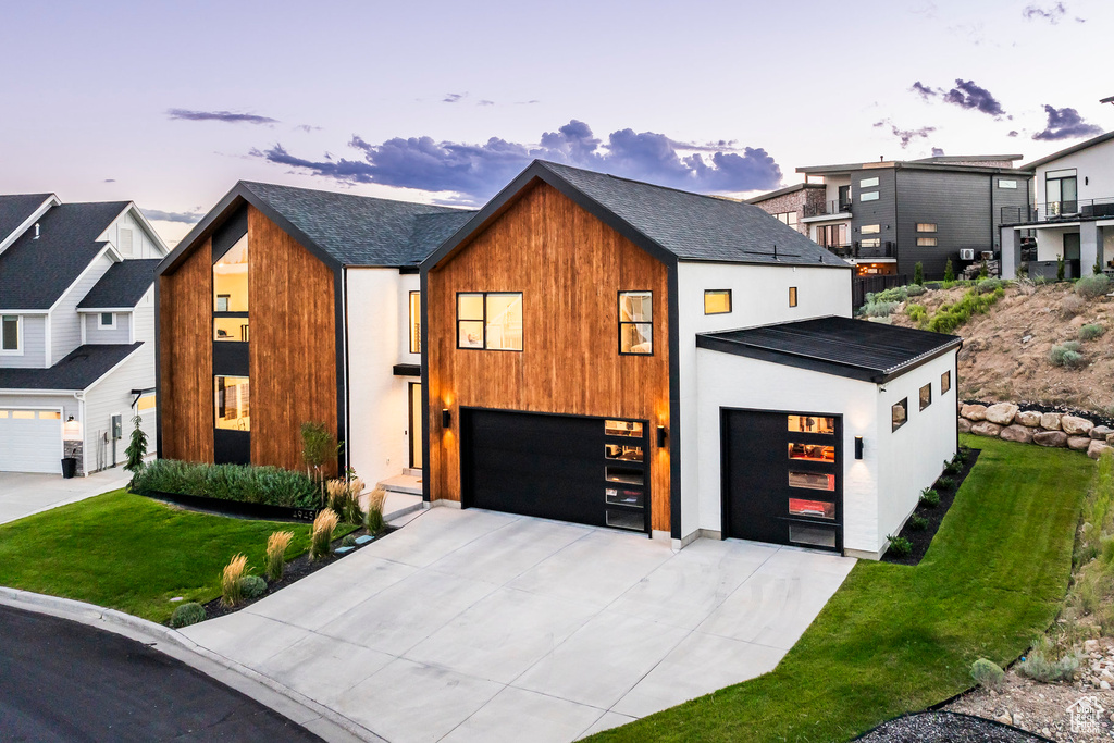 Contemporary house featuring a lawn and a garage