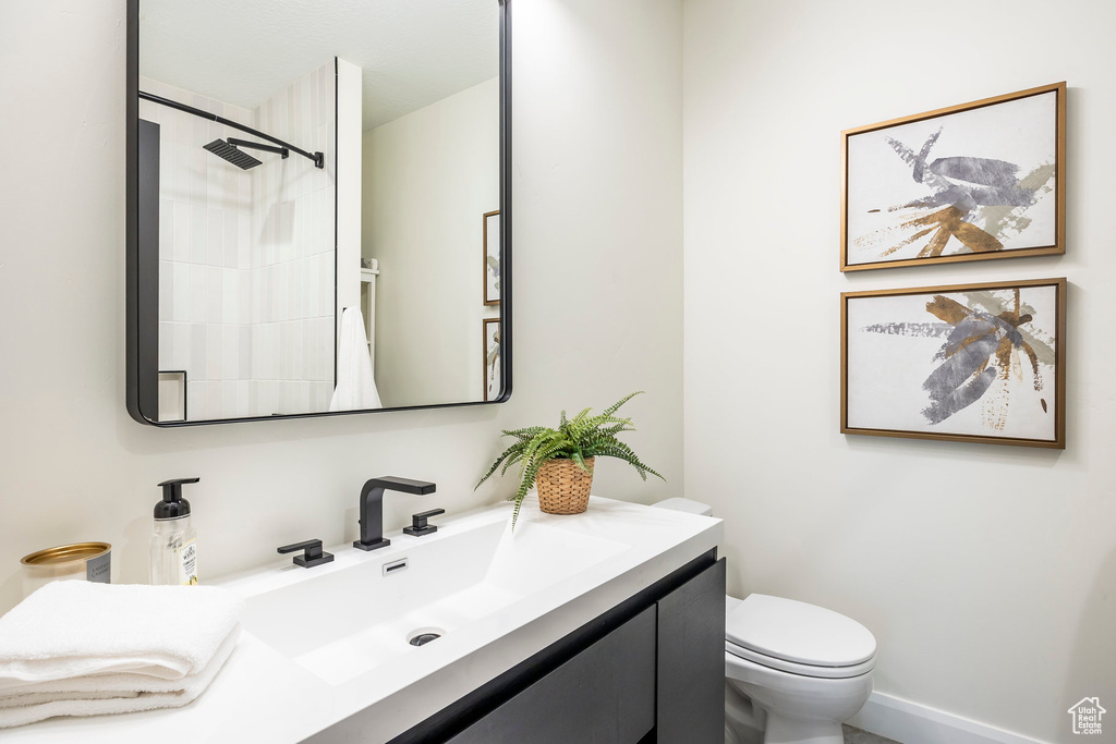 Bathroom with walk in shower, vanity, and toilet