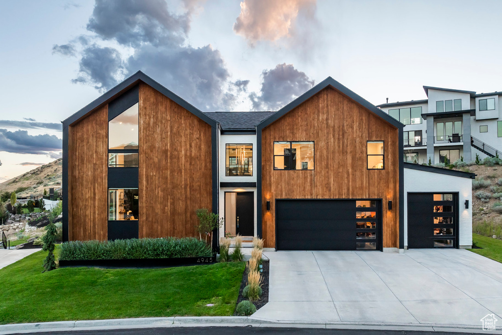 Contemporary home with a lawn and a garage