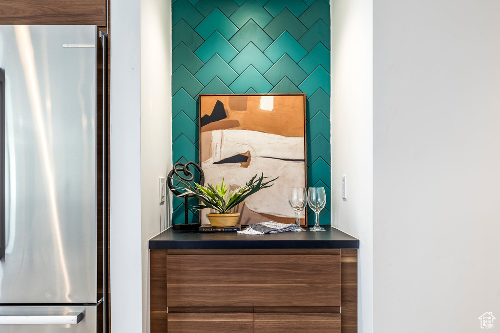 Interior details with stainless steel refrigerator and indoor bar