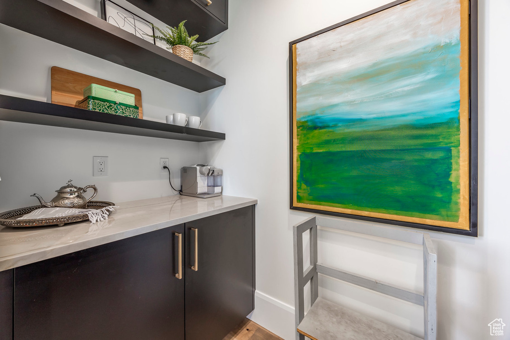 Bar featuring light stone countertops