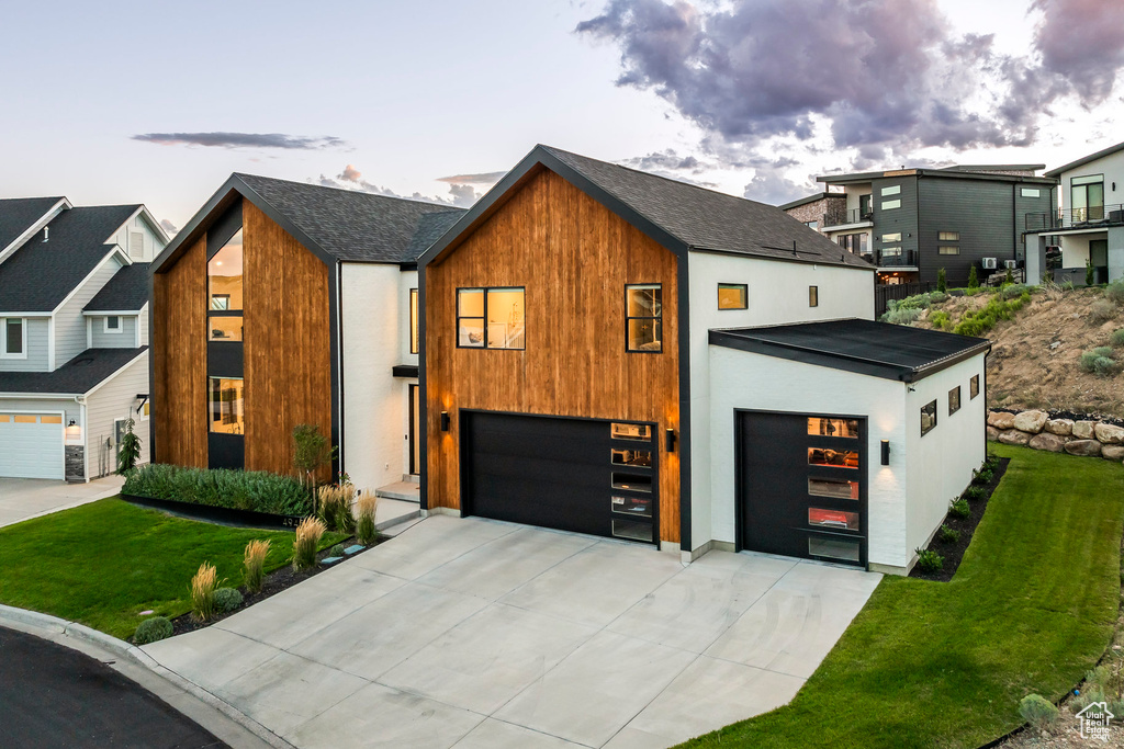 Contemporary house featuring a lawn and a garage