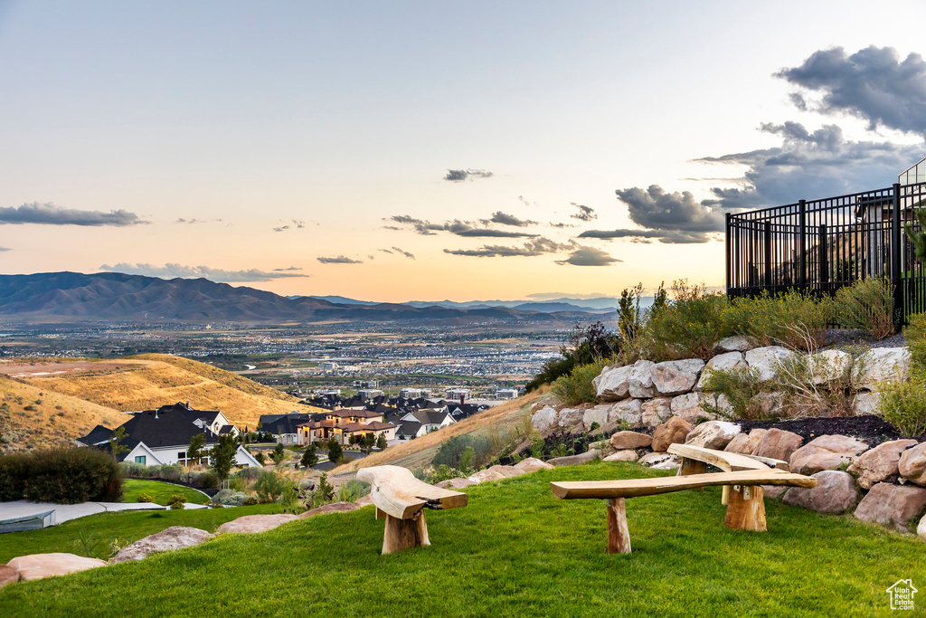 View of community featuring a mountain view and a yard