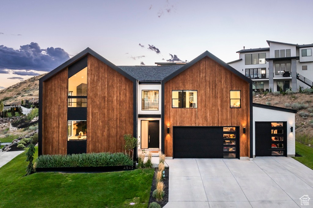 Contemporary house featuring a lawn and a garage
