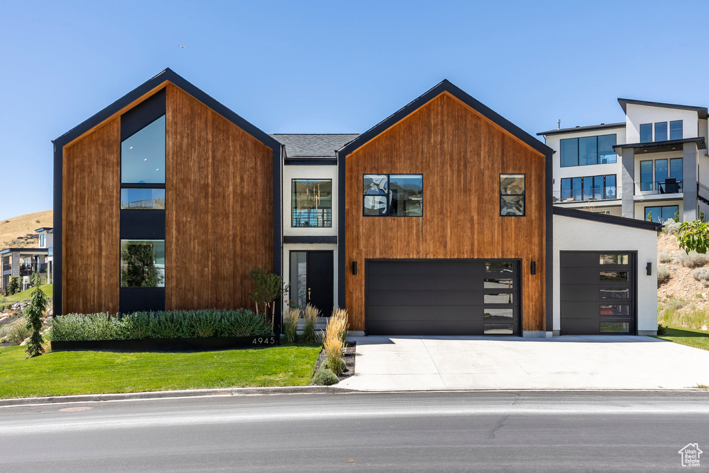 Modern home featuring a garage and a front yard