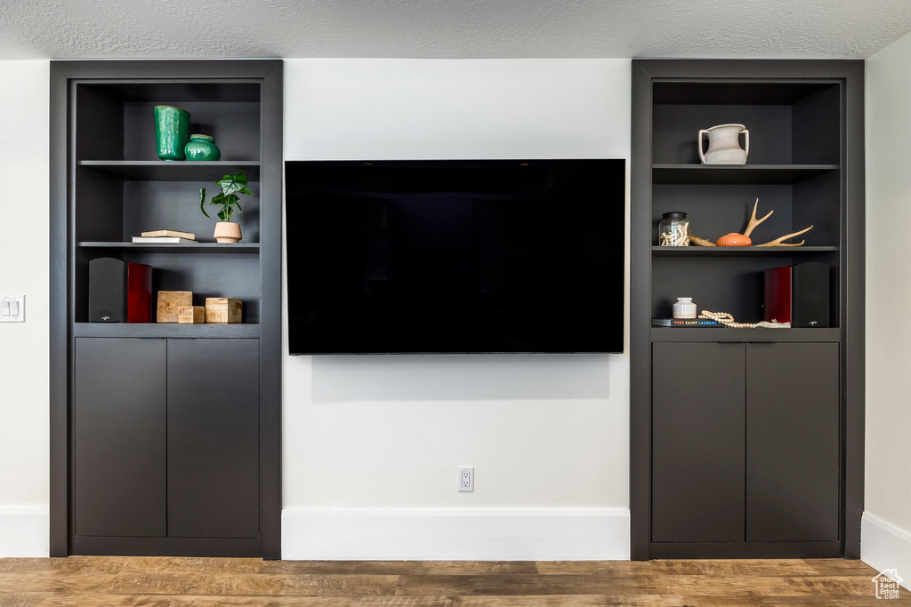 Interior space with built in shelves and a textured ceiling