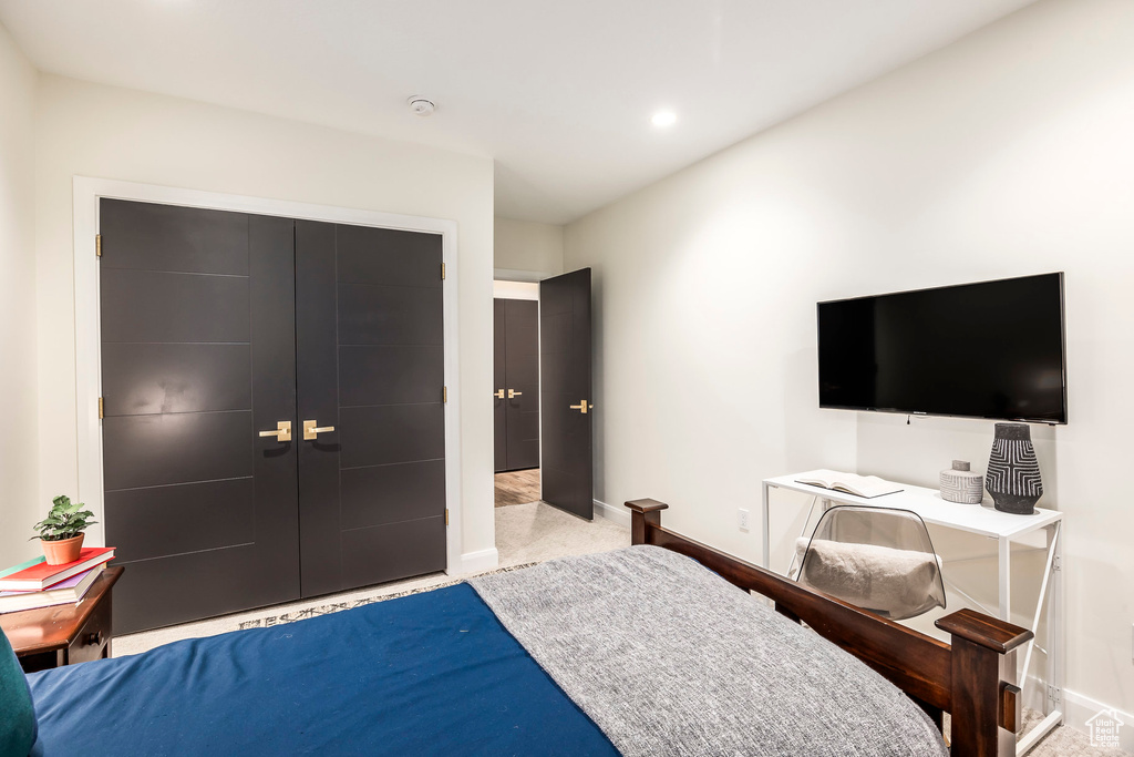 Carpeted bedroom featuring a closet