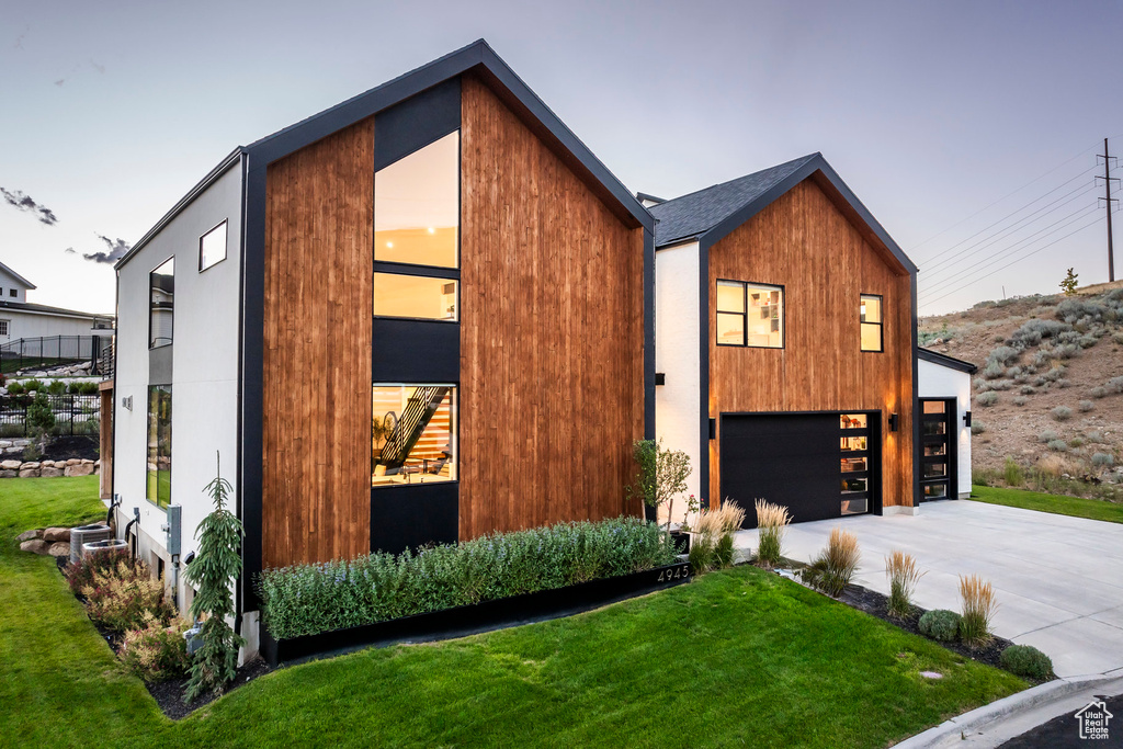 Modern home with a garage and a yard