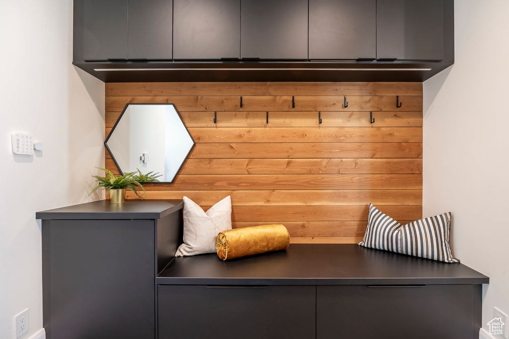 Mudroom featuring wood walls