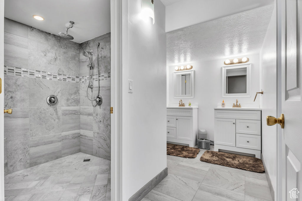 Bathroom with a tile shower and vanity