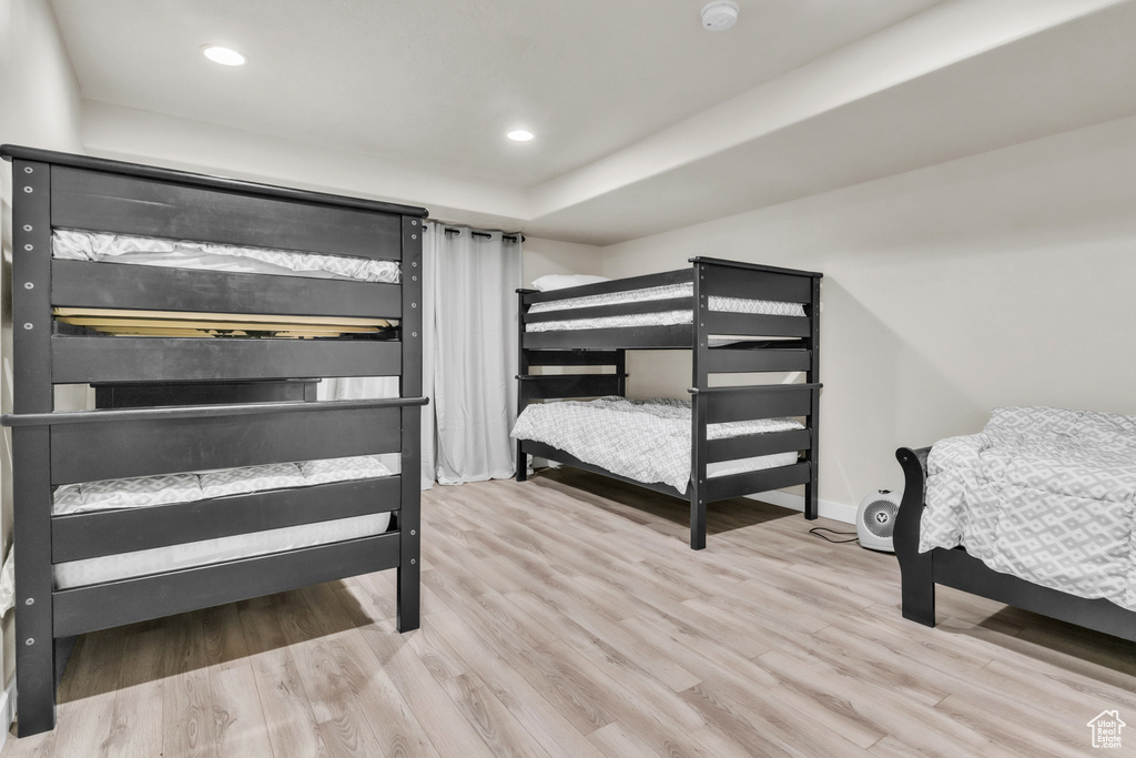 Bedroom with light hardwood / wood-style flooring