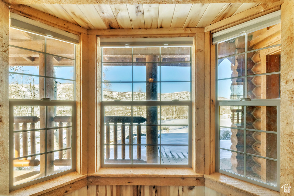 Doorway to outside with wood ceiling