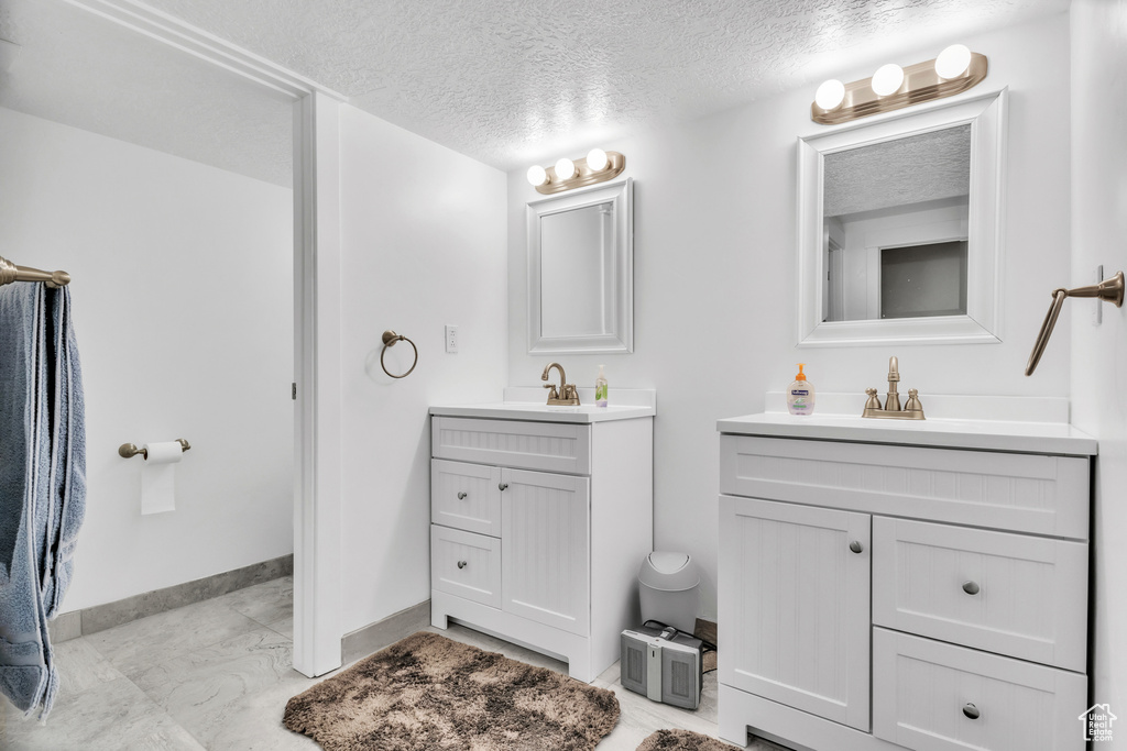 Bathroom with vanity and a textured ceiling