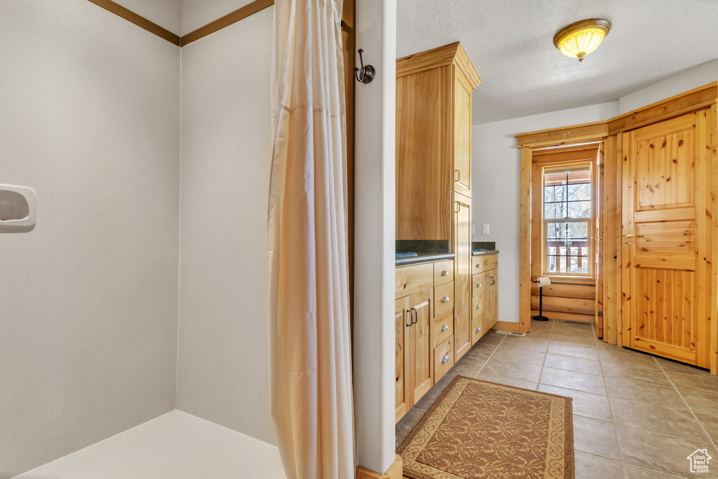 Bathroom featuring tile patterned flooring and vanity
