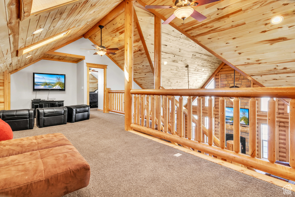 Additional living space with ceiling fan, carpet floors, and wooden ceiling