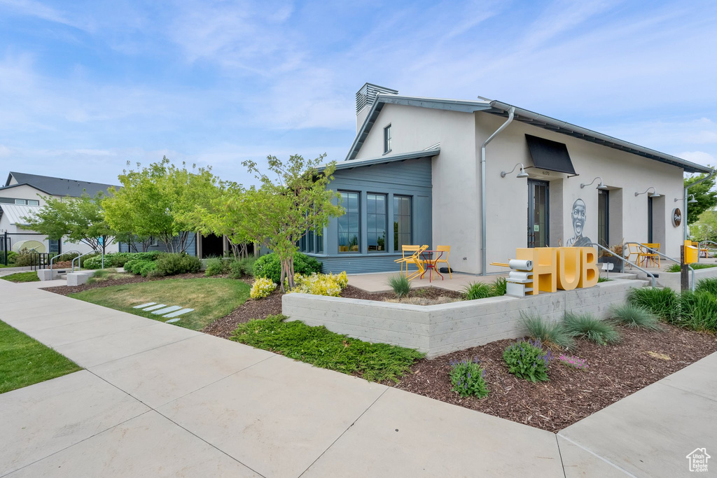 View of front of house with stucco siding and a chimney