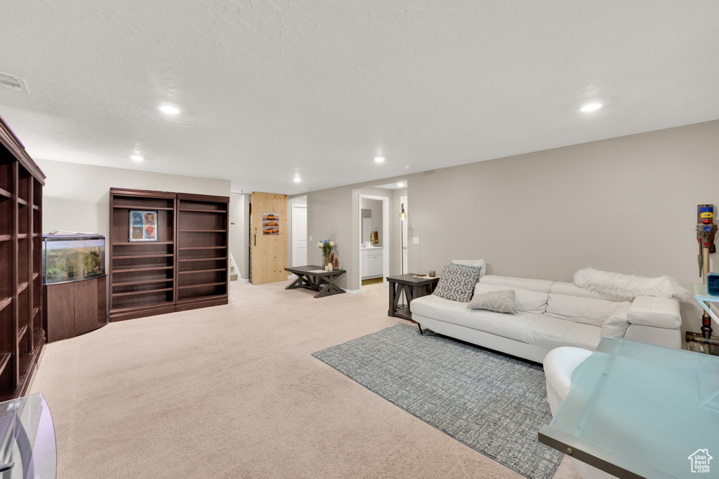 Carpeted living area featuring recessed lighting