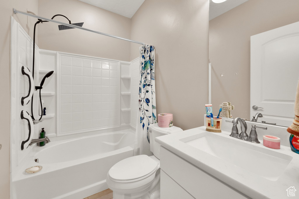 Full bath with toilet, shower / bathtub combination with curtain, and vanity