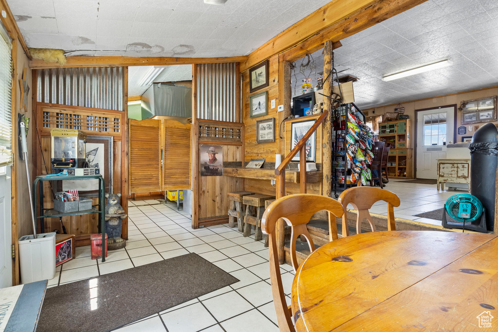 Tiled dining space with wood walls