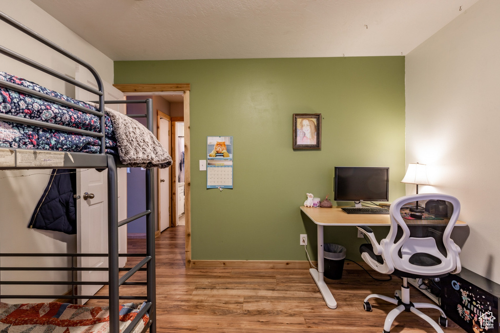 Bedroom with hardwood / wood-style flooring